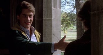 Movie still from “Class” (1983), directed by Lewis John Carlino – A man giving a thumbs up to another man; Medium shot, Over the shoulder angle