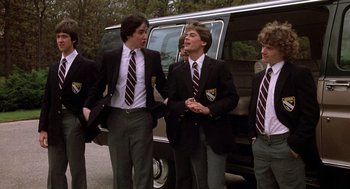 Movie still from “Class” (1983), directed by Lewis John Carlino – A group of young men standing next to each other near a van; Medium shot, Low angle