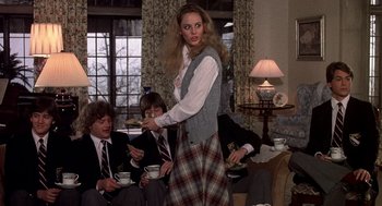 Movie still from “Class” (1983), directed by Lewis John Carlino – A woman in a plaid skirt is holding a plate; Medium shot, Over the shoulder angle