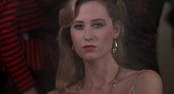 Movie still from “Class” (1983), directed by Lewis John Carlino – A woman with long blonde hair wearing a necklace and earrings; Close Up shot, Over the shoulder angle