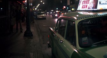 Movie still from “Class” (1983), directed by Lewis John Carlino – A green taxi cab parked on the side of the street; Wide shot, High angle