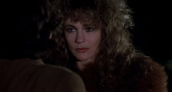 Movie still from “Class” (1983), directed by Lewis John Carlino – A person with curly hair; Close Up shot, Over the shoulder angle