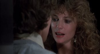 Movie still from “Class” (1983), directed by Lewis John Carlino – A person with their eyes closed; Close Up shot, Over the shoulder angle