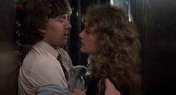 Movie still from “Class” (1983), directed by Lewis John Carlino – A man and a woman are kissing each other; Close Up shot, Over the shoulder angle