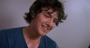 Movie still from “Class” (1983), directed by Lewis John Carlino – A person with wet hair; Close Up shot, Low angle