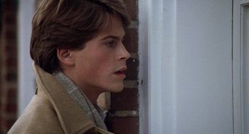 Movie still from “Class” (1983), directed by Lewis John Carlino – A young man in a brown jacket looking to his left; Close Up shot, Over the shoulder angle