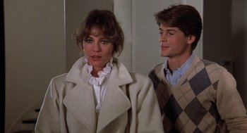 Movie still from “Class” (1983), directed by Lewis John Carlino – A man and a woman standing next to each other; Medium shot, Over the shoulder angle