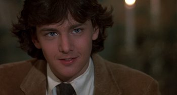 Movie still from “Class” (1983), directed by Lewis John Carlino – A young man wearing a brown jacket and a brown tie; Close Up shot, Over the shoulder angle