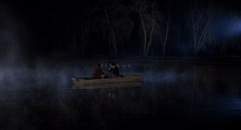 Movie still from “Class” (1983), directed by Lewis John Carlino – Two people in a boat on a body of water at night; Extreme Wide shot, High angle