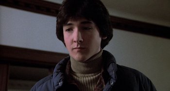 Movie still from “Class” (1983), directed by Lewis John Carlino – A young man in a sweater and a jacket; Close Up shot, Low angle