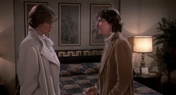 Movie still from “Class” (1983), directed by Lewis John Carlino – A man and a woman talking to each other in a room; Medium shot, Over the shoulder angle