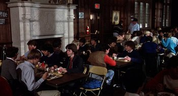 Movie still from “Class” (1983), directed by Lewis John Carlino – A group of people sitting at tables eating food; Wide shot, High angle