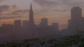 Movie still from “Class Action” (1991), directed by Michael Apted – A view of a city skyline at sunset; Extreme Wide shot, Low angle