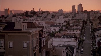 Movie still from “Class Action” (1991), directed by Michael Apted – A view of a city at sunset from a hill; Extreme Wide shot, High angle
