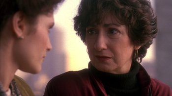 Movie still from “Class Action” (1991), directed by Michael Apted – An older woman and a younger man are talking to each other; Close Up shot, Over the shoulder angle