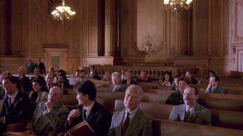 Movie still from “Class Action” (1991), directed by Michael Apted – A group of people sitting in a room; Wide shot, High angle