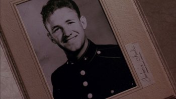 Movie still from “Class Action” (1991), directed by Michael Apted – An old photo of a man in a military uniform; Extreme Close Up shot, Low angle