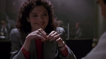 Movie still from “Class Action” (1991), directed by Michael Apted – A woman holding a pair of scissors in front of her face; Close Up shot, Over the shoulder angle