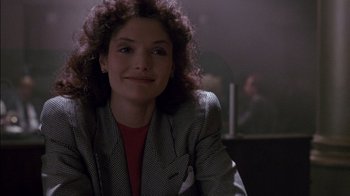Movie still from “Class Action” (1991), directed by Michael Apted – A woman sitting in front of a camera in a dark room; Close Up shot, Over the shoulder angle