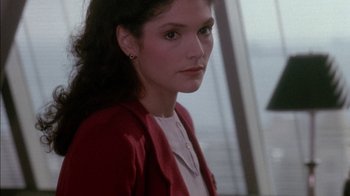 Movie still from “Class Action” (1991), directed by Michael Apted – A woman in a white shirt and a red jacket; Close Up shot, Over the shoulder angle