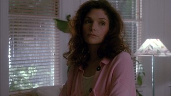 Movie still from “Class Action” (1991), directed by Michael Apted – A woman in a pink jacket is looking at the camera; Close Up shot, Low angle