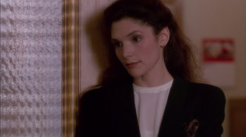 Movie still from “Class Action” (1991), directed by Michael Apted – A woman in a black jacket is looking at the camera; Close Up shot, High angle