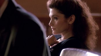 Movie still from “Class Action” (1991), directed by Michael Apted – A person sitting in a chair; Close Up shot, Over the shoulder angle