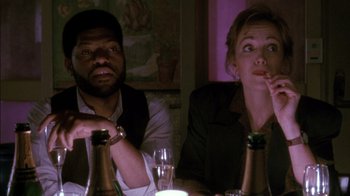 Movie still from “Class Action” (1991), directed by Michael Apted – A man and a woman sitting at a dinner table; Medium shot, Over the shoulder angle