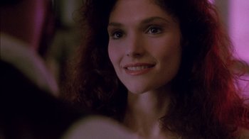 Movie still from “Class Action” (1991), directed by Michael Apted – A person with curly hair smiling; Close Up shot, Over the shoulder angle
