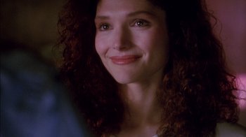 Movie still from “Class Action” (1991), directed by Michael Apted – A person with curly hair smiling; Close Up shot, Over the shoulder angle