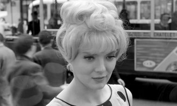 Movie still from “Cléo from 5 to 7” (1962), directed by Agnès Varda – A black and white photo of a woman with a bun; Close Up shot, Low angle