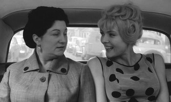 Movie still from “Cléo from 5 to 7” (1962), directed by Agnès Varda – Two women sitting next to each other in the back of a car; Close Up shot, High angle