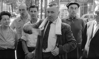 Movie still from “Cléo from 5 to 7” (1962), directed by Agnès Varda – A group of men standing next to each other on the street; Medium shot, Low angle