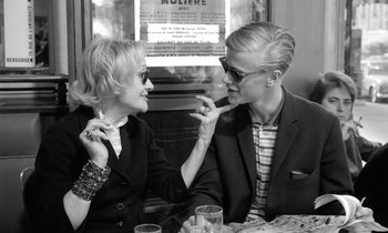 Movie still from “Cléo from 5 to 7” (1962), directed by Agnès Varda – A man and a woman sitting at a table; Medium shot, Over the shoulder angle
