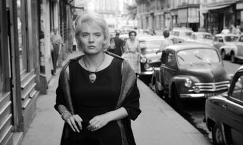 Movie still from “Cléo from 5 to 7” (1962), directed by Agnès Varda – Black and white photograph of a woman walking down the street; Close Up shot, Low angle