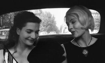 Movie still from “Cléo from 5 to 7” (1962), directed by Agnès Varda – Two women sitting in the back seat of a car; Close Up shot, High angle