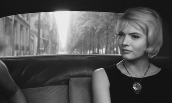 Movie still from “Cléo from 5 to 7” (1962), directed by Agnès Varda – A woman sitting in the back seat of a car; Close Up shot, Over the shoulder angle