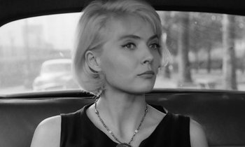 Movie still from “Cléo from 5 to 7” (1962), directed by Agnès Varda – Black and white photograph of a woman sitting in a car; Close Up shot, High angle