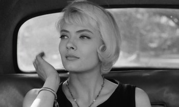 Movie still from “Cléo from 5 to 7” (1962), directed by Agnès Varda – A black and white photo of a woman sitting in the back of a car; Close Up shot, Low angle