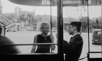 Movie still from “Cléo from 5 to 7” (1962), directed by Agnès Varda – An old photo of a man and a woman talking on a bus; Medium shot, Over the shoulder angle