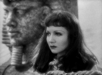 Movie still from “Cleopatra” (1934), directed by Cecil B. DeMille – A black and white photo of a woman with long black hair; Close Up shot, Low angle