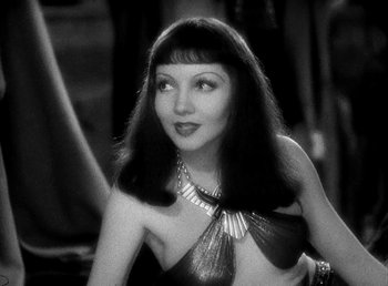 Movie still from “Cleopatra” (1934), directed by Cecil B. DeMille – A black - and - white photo of a woman with long black hair; Close Up shot, Over the shoulder angle