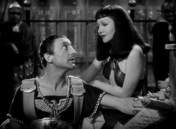 Movie still from “Cleopatra” (1934), directed by Cecil B. DeMille – A man and a woman are sitting on a bench; Medium shot, Over the shoulder angle