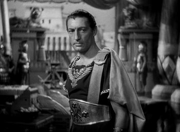 Movie still from “Cleopatra” (1934), directed by Cecil B. DeMille – A black and white photo of a man in a roman outfit; Medium shot, Low angle