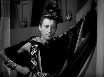 Movie still from “Cleopatra” (1934), directed by Cecil B. DeMille – A black and white photo of a man in a costume; Medium shot, Low angle