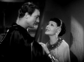 Movie still from “Cleopatra” (1934), directed by Cecil B. DeMille – A man and a woman are looking at one another; Medium shot, Over the shoulder angle