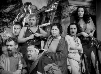 Movie still from “Cleopatra” (1934), directed by Cecil B. DeMille – A black and white photo of a group of people; Medium shot, High angle