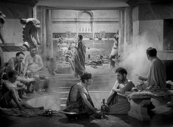 Movie still from “Cleopatra” (1934), directed by Cecil B. DeMille – A black and white photo of a group of people in a room; Wide shot, High angle