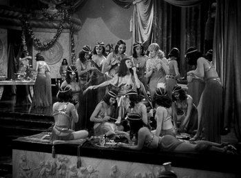 Movie still from “Cleopatra” (1934), directed by Cecil B. DeMille – A black and white photo of a group of women in bathing suits; Wide shot, High angle