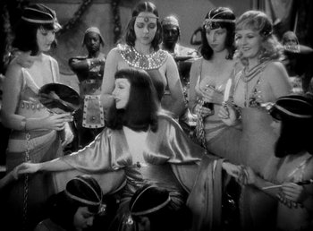 Movie still from “Cleopatra” (1934), directed by Cecil B. DeMille – A group of women standing next to each other in a room; Medium shot, High angle
